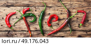 chili cayenne peppers. long poster with mexican hot peppers on old wooden background. Стоковое фото, агентство Ingram Publishing / Фотобанк Лори