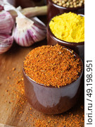 Spices and herbs in ceramic bowls. Food and cuisine ingredients. Colorful natural additives. Стоковое фото, агентство Ingram Publishing / Фотобанк Лори