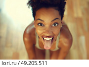 A woman sticks out her tongue in a humorous expression, creating a funny face. Стоковое AI-изображение, AI-художник Данила Большаков / Фотобанк Лори