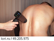 Discover the Benefits of Sports Massage With a Percussion Massager for Muscle Relief. Стоковое фото, фотограф Aleksandr Golubev / Фотобанк Лори