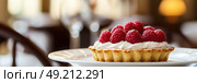 Appetizing raspberry tart and mint. Raspberry danish cake on plate on table and coffee. Tartlets raspberry fruit with vanilla custard, whipped cream served in a cafe. Blurred bokeh interior background. Стоковое AI-изображение, AI-художник Марина Демидюк / Фотобанк Лори
