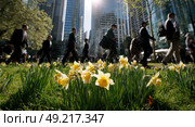 A group of people walk through a field of yellow flowers. Стоковое AI-изображение, AI-художник Ярославский Максим / Фотобанк Лори