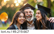 A joyful elderly man in graduation attire hugs two young women in caps and gowns, celebrating their academic achievements. Стоковое AI-изображение, AI-художник Данила Большаков / Фотобанк Лори