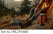 A man sitting on a rock next to a tent in the wilderness. Стоковое AI-изображение, AI-художник Данила Большаков / Фотобанк Лори