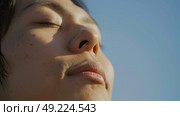A close-up shot of a person with their eyes shut, showing the peacefulness of their expression. Стоковое AI-изображение, AI-художник Данила Большаков / Фотобанк Лори
