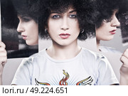Interesting portrait of a girl in an afro wig. Стоковое фото, агентство Ingram Publishing / Фотобанк Лори