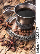 Coffee in the oriental style. Vintage set with a cup of coffee on saucer in oriental style. Стоковое фото, агентство Ingram Publishing / Фотобанк Лори