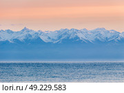 Issyk-Kul lake, snow-capped mountains and pink sky in the morning. Kyrgyzstan (2017 год). Стоковое фото, фотограф Максим Забаровский / Фотобанк Лори