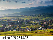 Town on hills of tatra mountain range. Villages on green fields. Стоковое фото, агентство Ingram Publishing / Фотобанк Лори