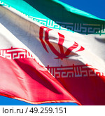 in iran blur  iranian waving flag  the blue sky and wind. Стоковое фото, агентство Ingram Publishing / Фотобанк Лори