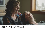 Two women are reclining on a couch in a relaxed posture, enjoying each others company. Стоковое AI-изображение, AI-художник Данила Большаков / Фотобанк Лори