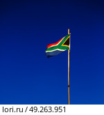 in south africa close up of the blur  national flag on pole. Стоковое фото, агентство Ingram Publishing / Фотобанк Лори