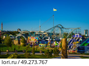 Tashkent, Uzbekistan - August 15, 2023: Amusement park Navruz or Ankhor In Tashkent with attractions and garlands. Редакционное фото, фотограф Емельянов Евгений Викторович / Фотобанк Лори