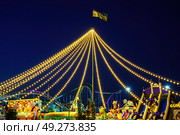 Tashkent, Uzbekistan - August 15, 2023: Amusement park Navruz or Ankhor In Tashkent with attractions and garlands at night. Редакционное фото, фотограф Емельянов Евгений Викторович / Фотобанк Лори