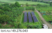 Aerial shot of renewable energy village with sustainable farming. Стоковое видео, видеограф ALEJANDRO PEREZ ALVARES / Фотобанк Лори