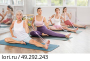 Group of women of different ages doing Pilates or aerobics using an expander in gym. Стоковое фото, фотограф Яков Филимонов / Фотобанк Лори