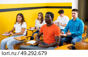 Lesson in the classroom of the driving school - students at their desks and take a theoretical course of work in taxi. Стоковое фото, фотограф Яков Филимонов / Фотобанк Лори