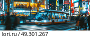 A city street at night, illuminated by streetlights, with a bus parked on the side and people walking on the sidewalks. Стоковое AI-изображение, AI-художник Данила Большаков / Фотобанк Лори