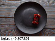 Grilled smoked eel on black plate modern cuisine gastronomy. Стоковое фото, агентство Ingram Publishing / Фотобанк Лори