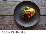 endive little Lettuce grilled with vinaigrette sauce on black plate. Стоковое фото, агентство Ingram Publishing / Фотобанк Лори