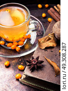 healthy tea with sea-buckthorn. cup with healing tea with sea-buckthorn on wooden retro background. Стоковое фото, агентство Ingram Publishing / Фотобанк Лори