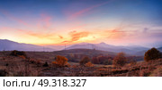 Mountain autumn panoramic landscape with colorful forest. Panorama of sunset in a Carpathian mountain valley with wonderful gold light on a hills. Panoramic image of rural fields in evening light. Стоковое фото, агентство Ingram Publishing / Фотобанк Лори