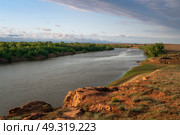 View from the steep bank of the Ashuluk River near the Sarai-Batu tourist center on a sunny summer day, Kharabalinsky district, Astrakhan region, Russia. Стоковое фото, фотограф Ula Ulachka / Фотобанк Лори
