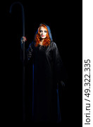 Young witch isolated on black. Стоковое фото, агентство Ingram Publishing / Фотобанк Лори