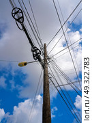 Messy electric aerial wires and pole in Mexico. Стоковое фото, агентство Ingram Publishing / Фотобанк Лори