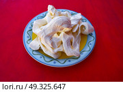 Oaxaca cheese from Mexico in a plate on red background. Стоковое фото, агентство Ingram Publishing / Фотобанк Лори