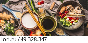 Vegetarian stir fry ingredients: chopped vegetables, spices,coconut milk, soy sauce,,wok and chopsticks, top view, banner. Asian food , Chinese or Thai cuisine concept. Стоковое фото, агентство Ingram Publishing / Фотобанк Лори