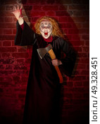 Scary witch on brick background. Стоковое фото, агентство Ingram Publishing / Фотобанк Лори
