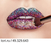 Close up view of Beautiful Woman Lips with Colorful Lipstick. Open Mouth with white Teeth. Cosmetology, drugstore or Fashion Makeup Concept.  Beauty studio shot. Passionate Kiss. Стоковое фото, агентство Ingram Publishing / Фотобанк Лори