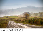 Muddy ground and country road after rain in Carpathian mountains. Extreme path rural dirt road in the hills. Bad weather. Стоковое фото, агентство Ingram Publishing / Фотобанк Лори