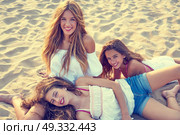 Best friends teen girls together relaxed on a beach sand at sunset. Стоковое фото, агентство Ingram Publishing / Фотобанк Лори