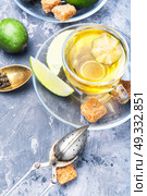 Tea with lime and feijoa. Hot tea with feijoa and lime on blue background. Стоковое фото, агентство Ingram Publishing / Фотобанк Лори