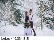 groom in a brown and bride in burgundy in the mountains Carpathians. Стоковое фото, агентство Ingram Publishing / Фотобанк Лори