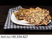 cookies with sunflower seeds and sesame seeds on a white plate with checkered napkin. Стоковое фото, агентство Ingram Publishing / Фотобанк Лори