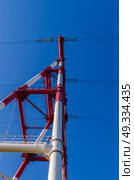 supports of high-voltage power lines against the blue sky. Стоковое фото, агентство Ingram Publishing / Фотобанк Лори