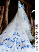 bridesmaid dress in the style of Gzhel hanging on a wooden beam in the input aperture of the house. Стоковое фото, агентство Ingram Publishing / Фотобанк Лори