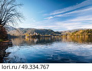Lake Bled in the Alpine mountains in autumn under blue sky. Стоковое фото, агентство Ingram Publishing / Фотобанк Лори