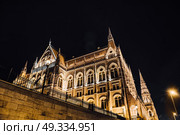 The Hungarian Parliament in Budapest on the Danube in the night lights of the street lamps. Стоковое фото, агентство Ingram Publishing / Фотобанк Лори