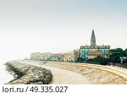 Belltower Duomo Santo Stefano on the seacoast coast in Caorle Italy. Стоковое фото, агентство Ingram Publishing / Фотобанк Лори