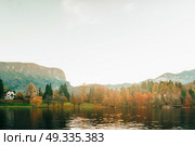Lake Bled in the Alpine mountains in autumn under blue sky. Стоковое фото, агентство Ingram Publishing / Фотобанк Лори