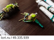 boutonniere made of cotton lying on a brown table with lace, scrolls of old parchment. Стоковое фото, агентство Ingram Publishing / Фотобанк Лори