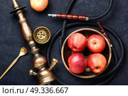 Nargile with apple. Smoking smoking shisha in east style with tobacco aroma of red apple.Apple hookah. Стоковое фото, агентство Ingram Publishing / Фотобанк Лори
