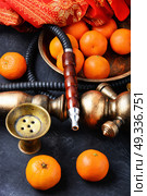 Nargile with mandarin. Smoking smoking shisha in east style with tobacco aroma of mandarin. Стоковое фото, агентство Ingram Publishing / Фотобанк Лори