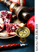 hookah with pomegranate. Exotic smoking shisha in east style with tobacco aroma of pomegranate.Fruit hookah. Стоковое фото, агентство Ingram Publishing / Фотобанк Лори