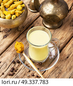 Turmeric Golden milk. Turmeric Golden milk in a glass cup. Стоковое фото, агентство Ingram Publishing / Фотобанк Лори