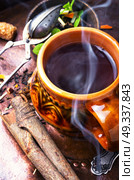 Hot herbal tea. Clay cup with herbal tea on a vintage background. Стоковое фото, агентство Ingram Publishing / Фотобанк Лори